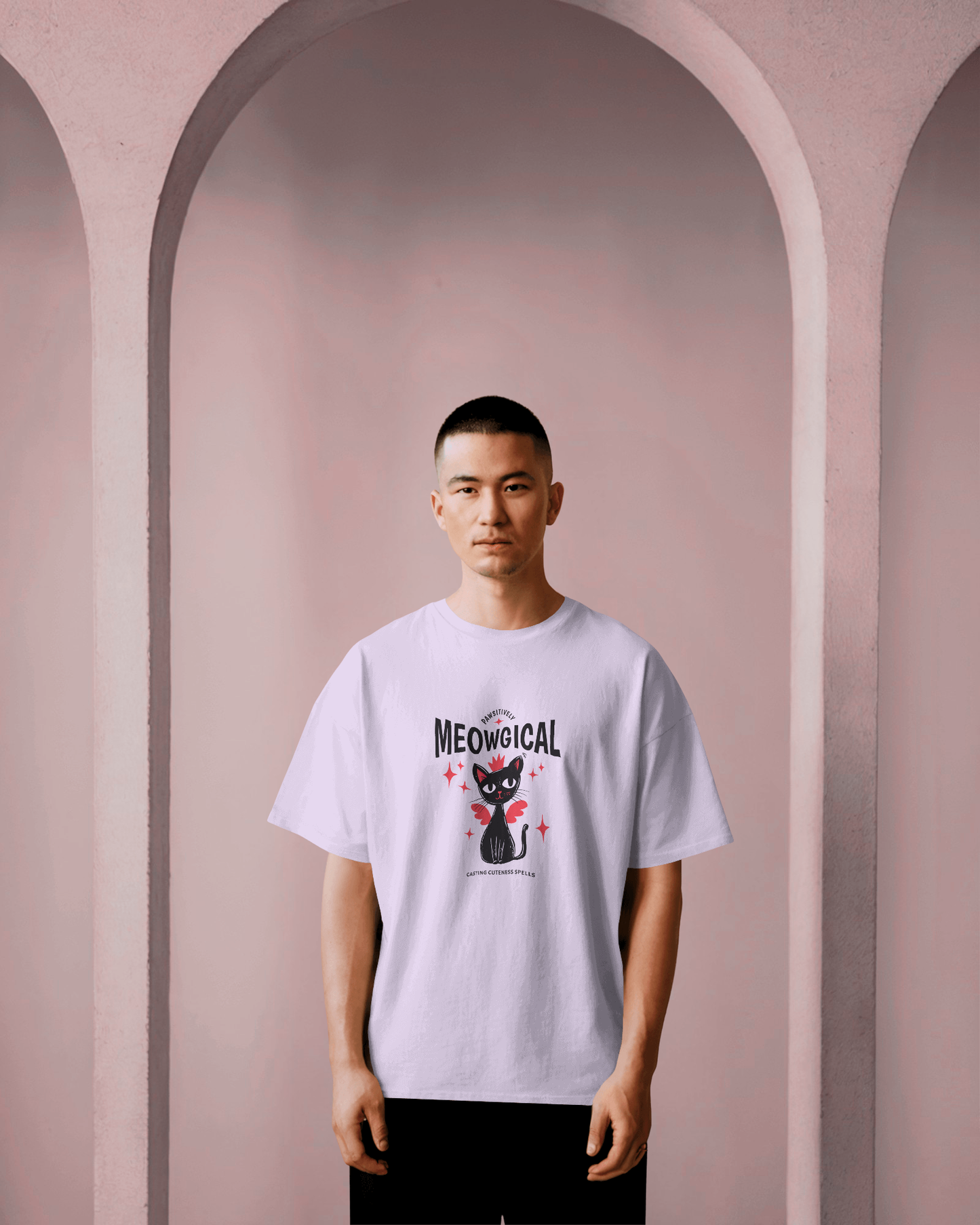 Male model wearing a Qurrito white oversized t-shirt with a graphic "Meowgical" design against a purple background