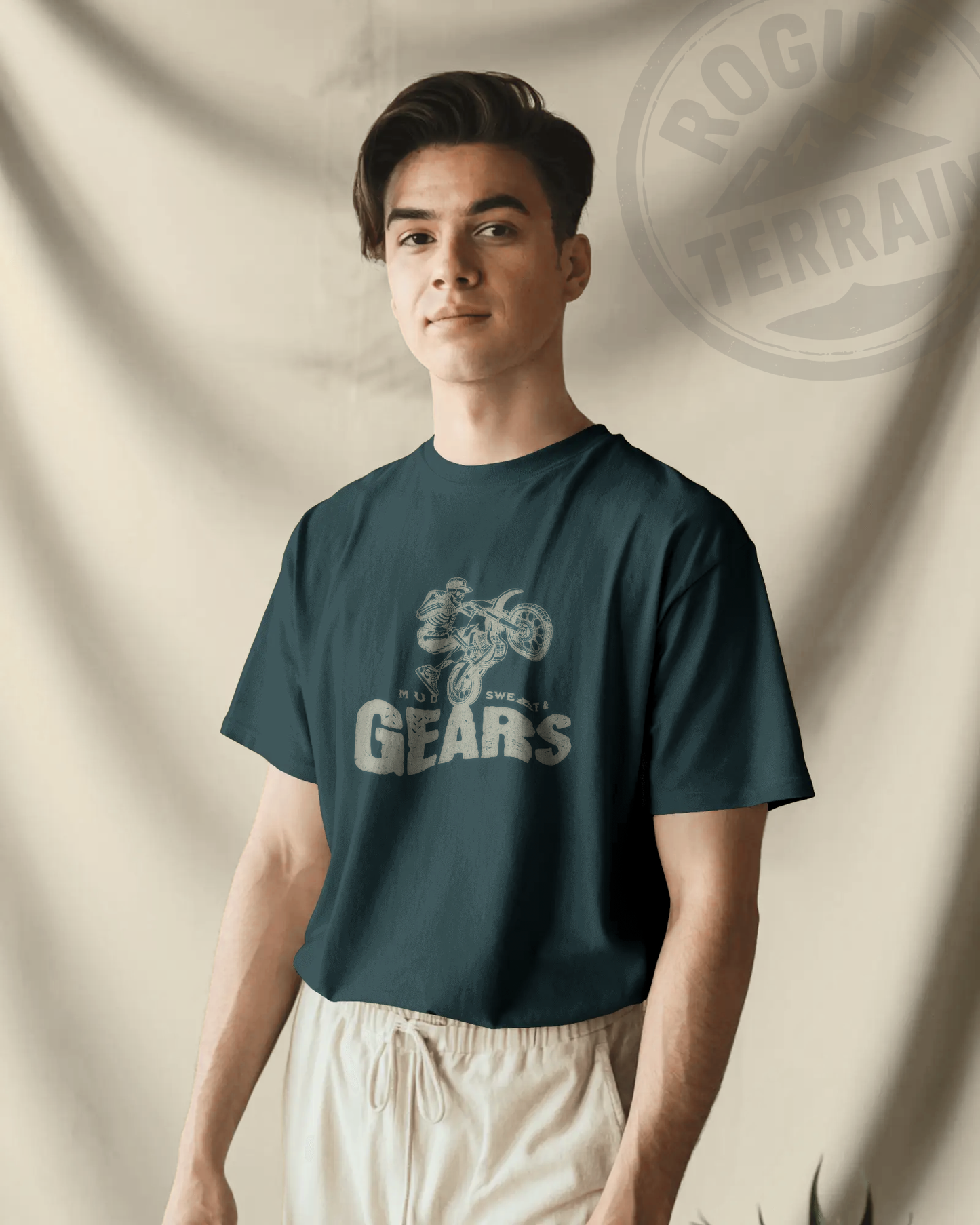 Male model wearing Qurrito’s Motorbike Graphic T-Shirt featuring a skeleton biker design and “Mud Sweat & Gears” typography. This regular-fit cotton tee combines dark streetwear aesthetics with an adventurous vibe, expressing energetic, pumped, mysterious, and dark moods — perfect for riders and edgy style lovers.