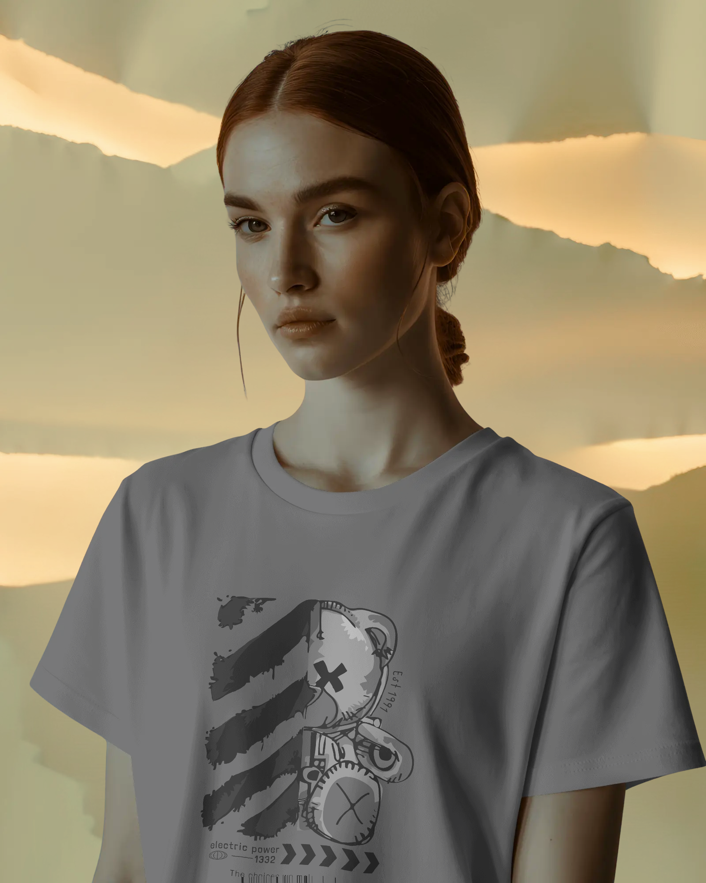 Close-up of a female model giving a confident and mysterious look while wearing the Qurrito Goth Teddy t-shirt. The futuristic graphic tee is a regular fit and comes in a dark gray color.