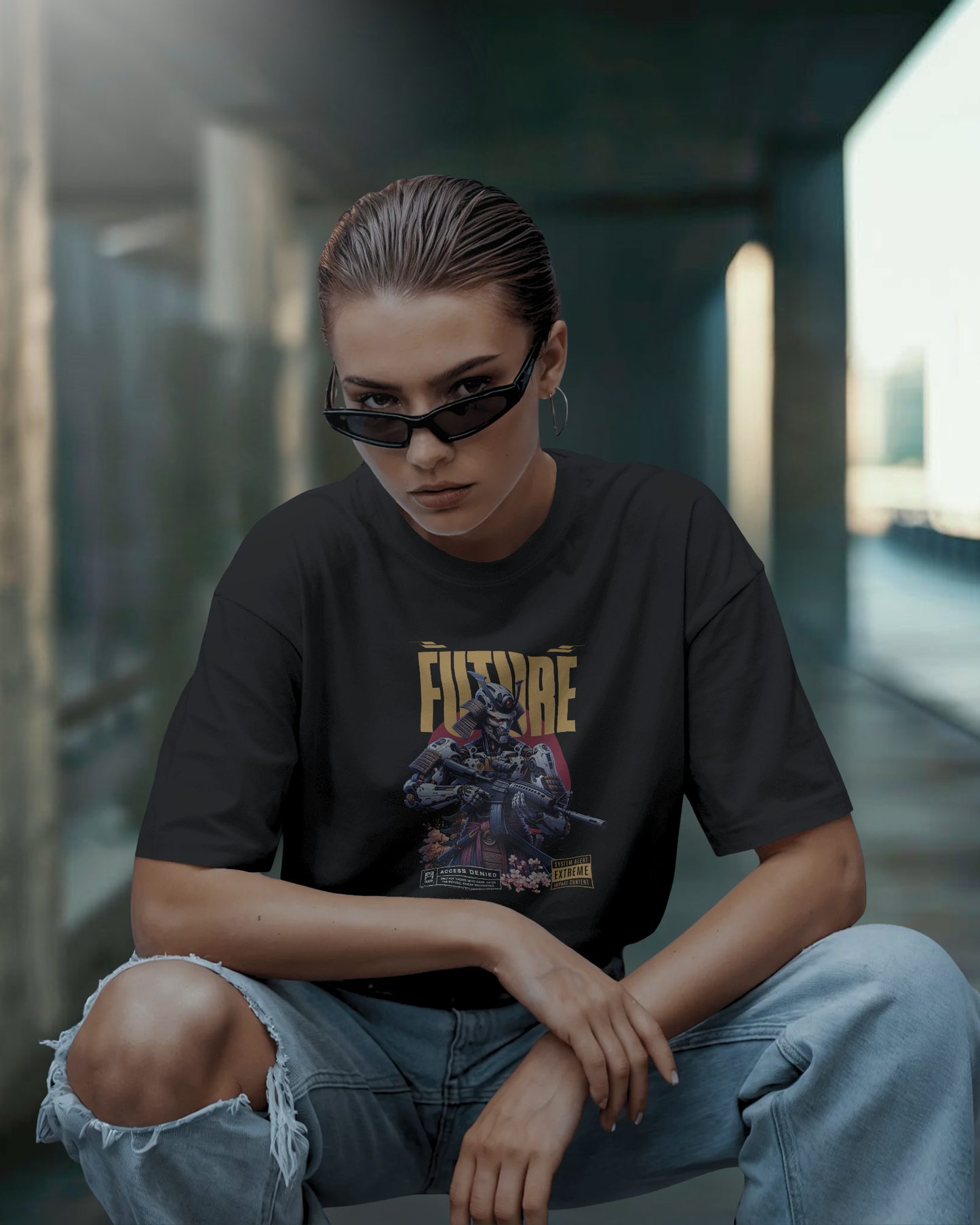 Woman wearing Qurrito’s Dark Side of the Future Cyber Mecha Oversized T-Shirt in black, paired with ripped high-waist jeans and slim black sunglasses. The look gives off mysterious, confident, and dark cyberpunk mood streetwear vibes, perfect for women searching for bold graphic tees with jeans.