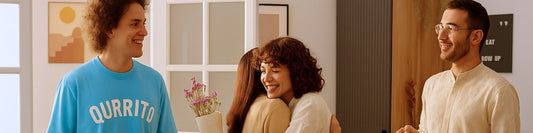 Friends celebrating Diwali indoors, one wearing Qurrito baby blue Cheerful Mood Oversized T-Shirt, sharing hugs and smiles in a festive setting.