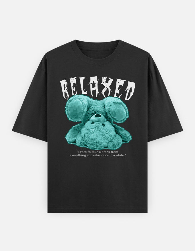 Oversized black t-shirt with upside-down turquoise teddy and "RELAXED" graphic, made from soft casual chillwear cotton.