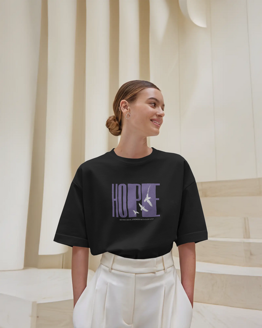 a woman wearing Black Graphic Oversized T-Shirt – HOPE Unisex Streetwear by QURRiTO