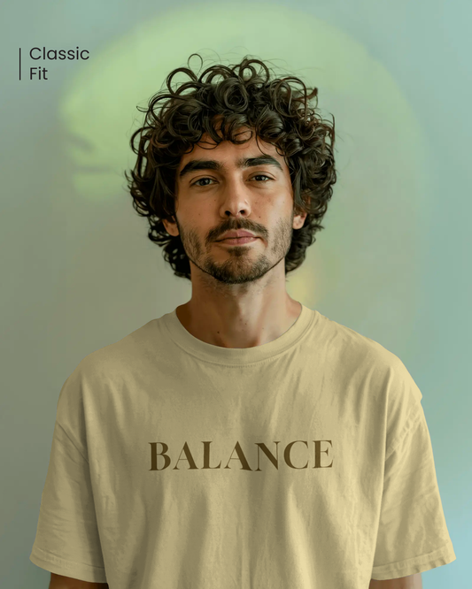 Male model in Qurrito’s Beige Balance Regular Fit Cotton T-Shirt styled casually for a minimalist streetwear look. The design embodies serious, focused, chill, and relaxed moods — a timeless piece that blends calm confidence with comfort.