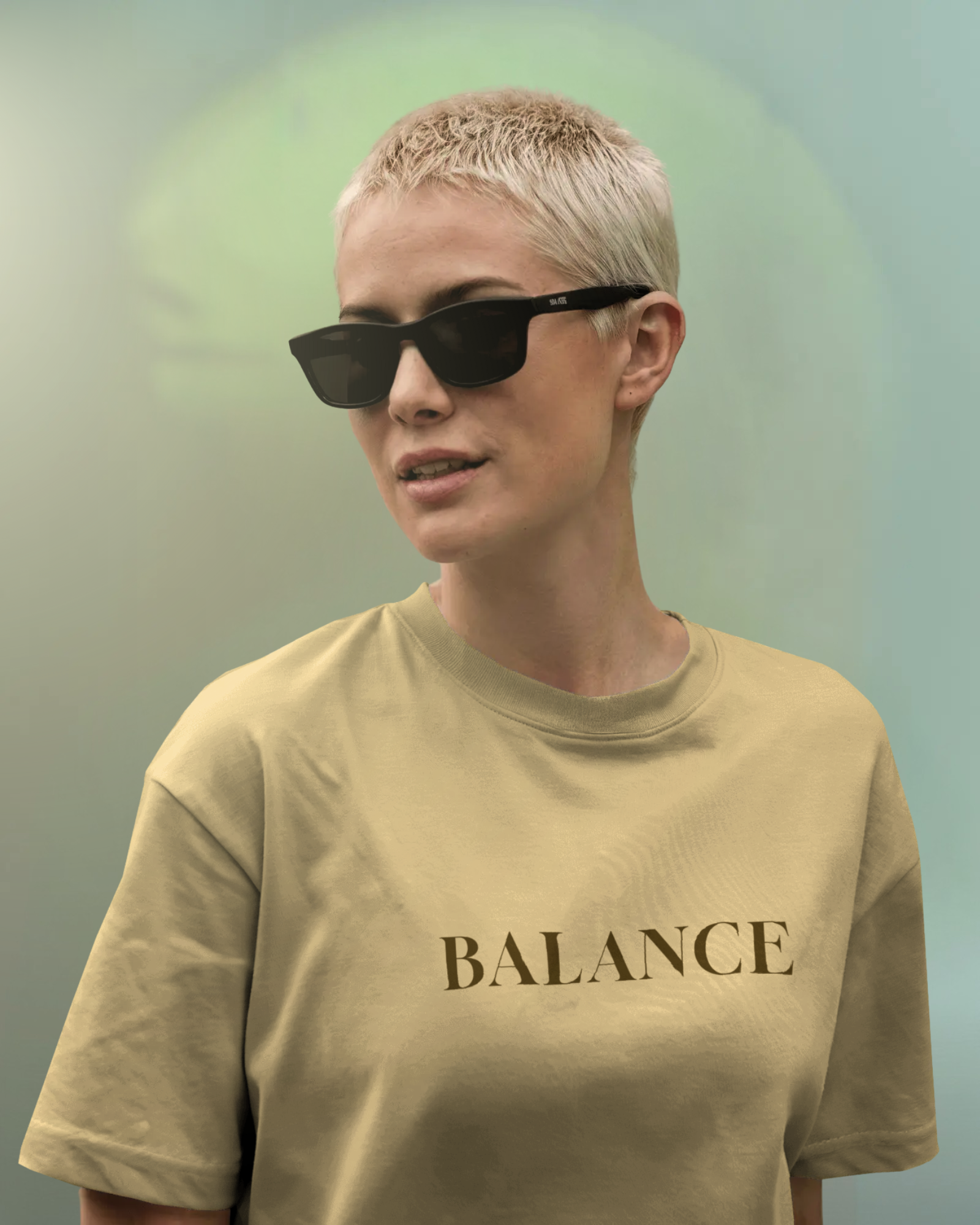 Female model wearing Qurrito’s Balance Regular Fit T-Shirt in beige minimalist design. The soft cotton tee radiates serious, focused, calm, chill, and relaxed mood energy — perfect for streetwear enthusiasts seeking effortless balance and simplicity.