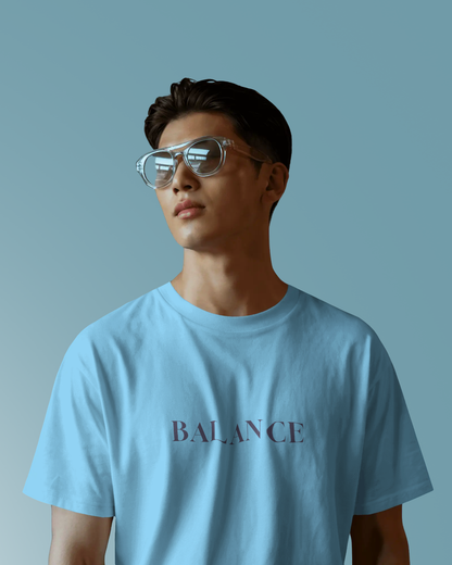 Male model wearing Qurrito’s Balance Regular Fit T-Shirt in blue minimalist design. The clean typography and soft cotton fabric reflect serious, focused, chill, and relaxed moods — perfect for effortless streetwear with calm confidence.
