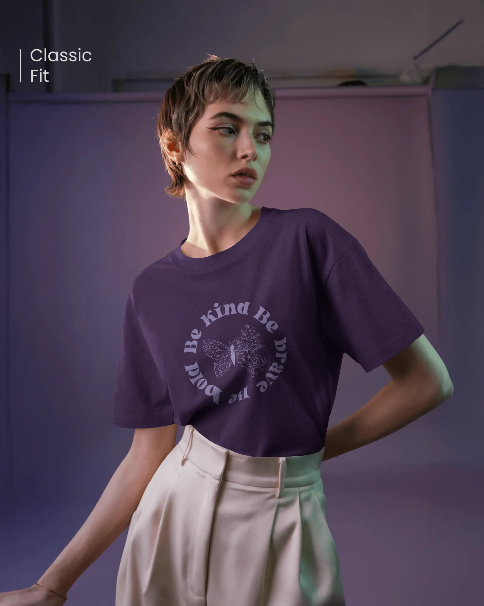 Woman wearing Qurrito’s Be Kind Be Brave Be Bold Regular Fit Tee in purple floral design. The cotton t-shirt embodies romantic, affectionate, happy, and cheerful moods — spreading empowerment and positivity through minimalist streetwear.