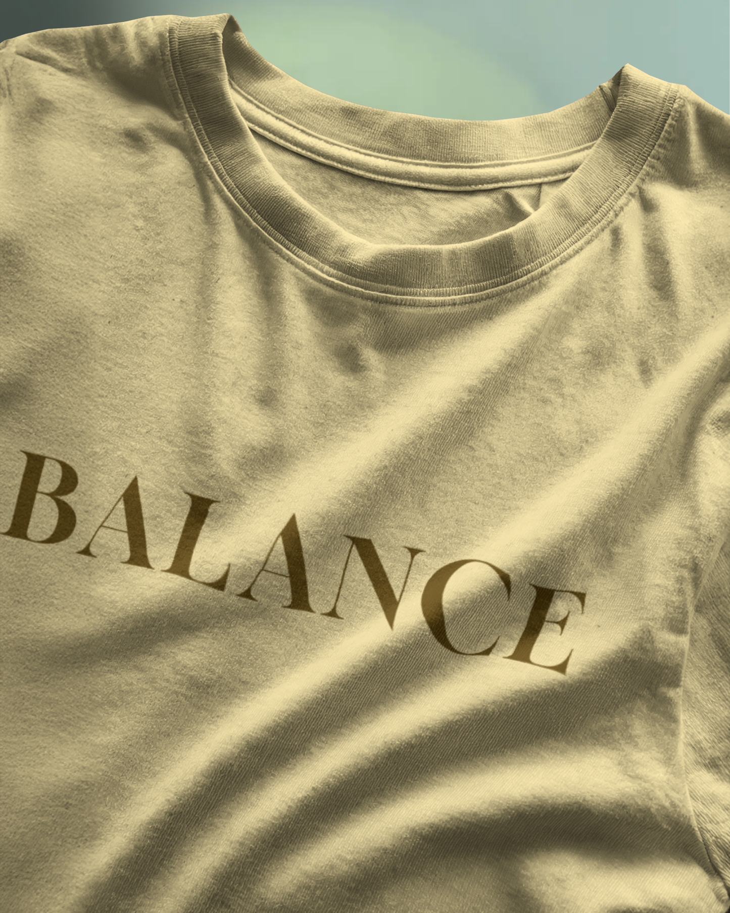 Close-up of Qurrito’s Beige Balance Regular Fit T-Shirt featuring minimalist typography. Crafted from premium cotton, this tee reflects relaxed, chill, focused, and serious moods — ideal for minimal streetwear lovers who appreciate balance in style.