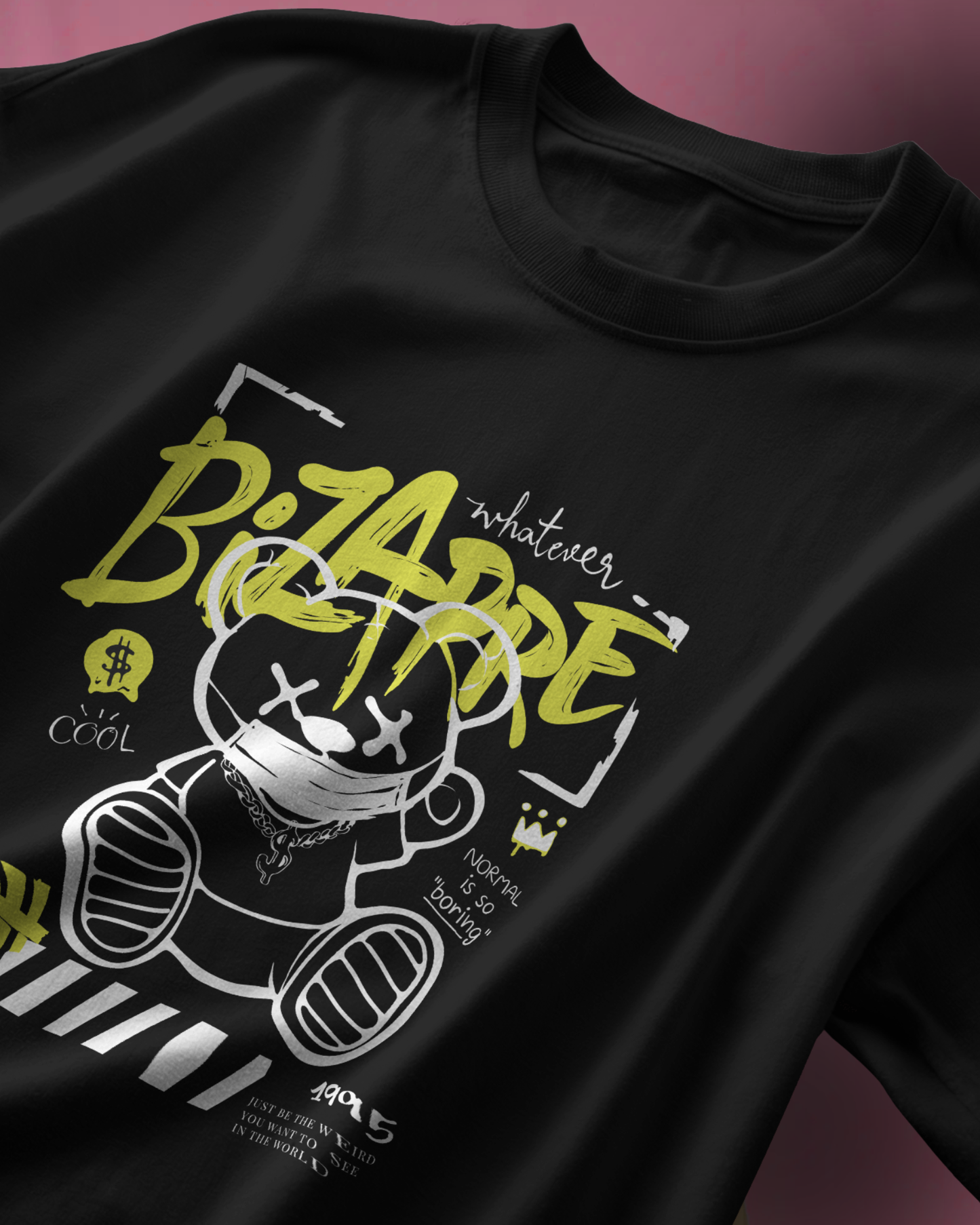 Closeup detail of the quirky "Bizarre" masked bear graphic on a black T-shirt. Playful street art style. Oversized Fit Qurrito Cotton.