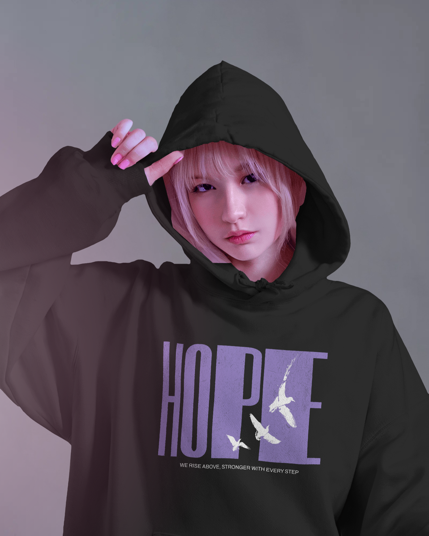 Female model wearing Qurrito’s Black Hope Unisex Oversized Hoodie featuring purple “HOPE” typography with flying white birds graphic, made from premium heavy fabric for a relaxed streetwear look.