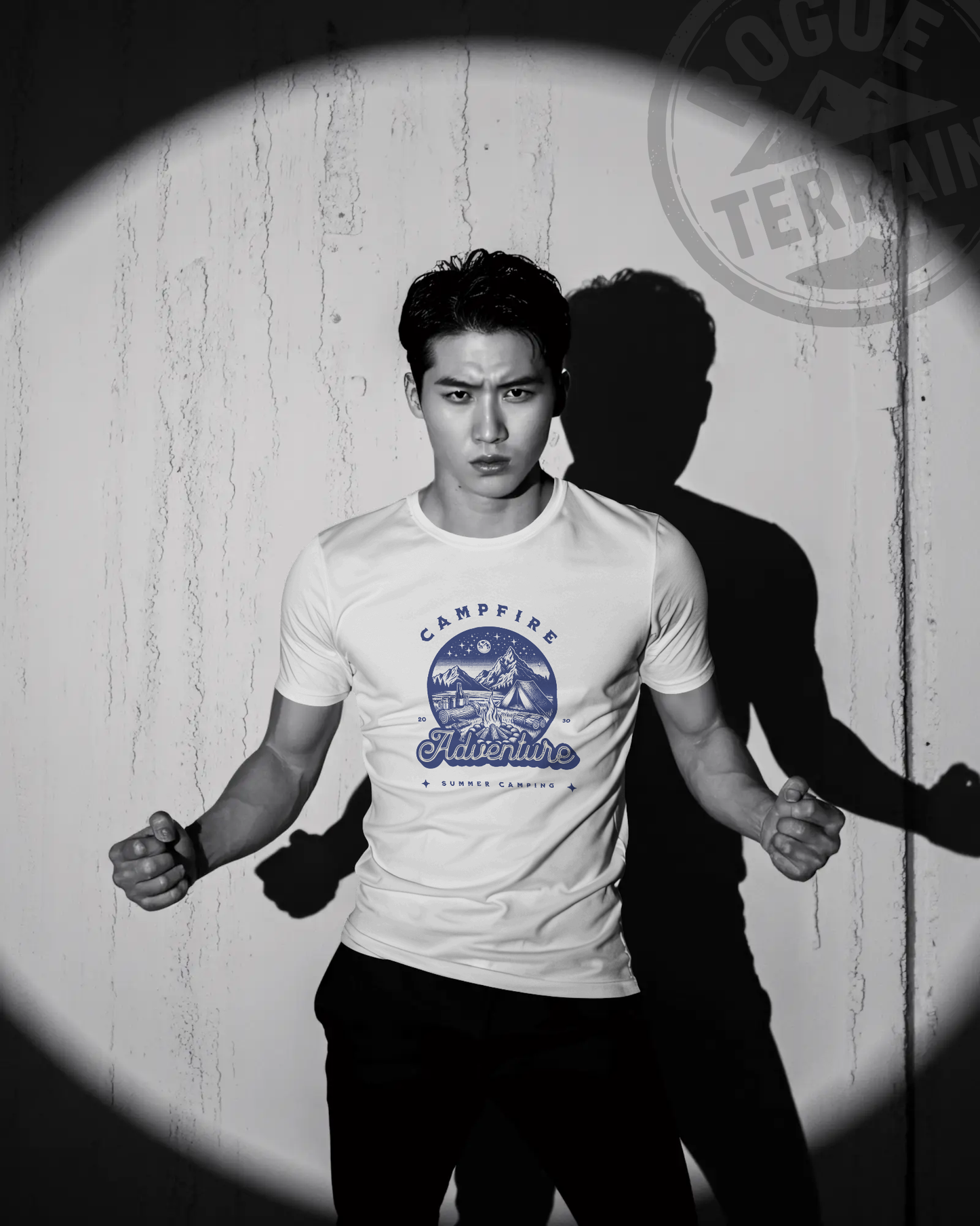 Male model wearing Qurrito’s Campfire Adventure Regular Fit T-Shirt in white, printed with a blue mountain and camping graphic. This summer cotton tee captures romantic, affectionate, chill, relaxed, happy, and cheerful moods — a perfect choice for outdoor adventure enthusiasts.