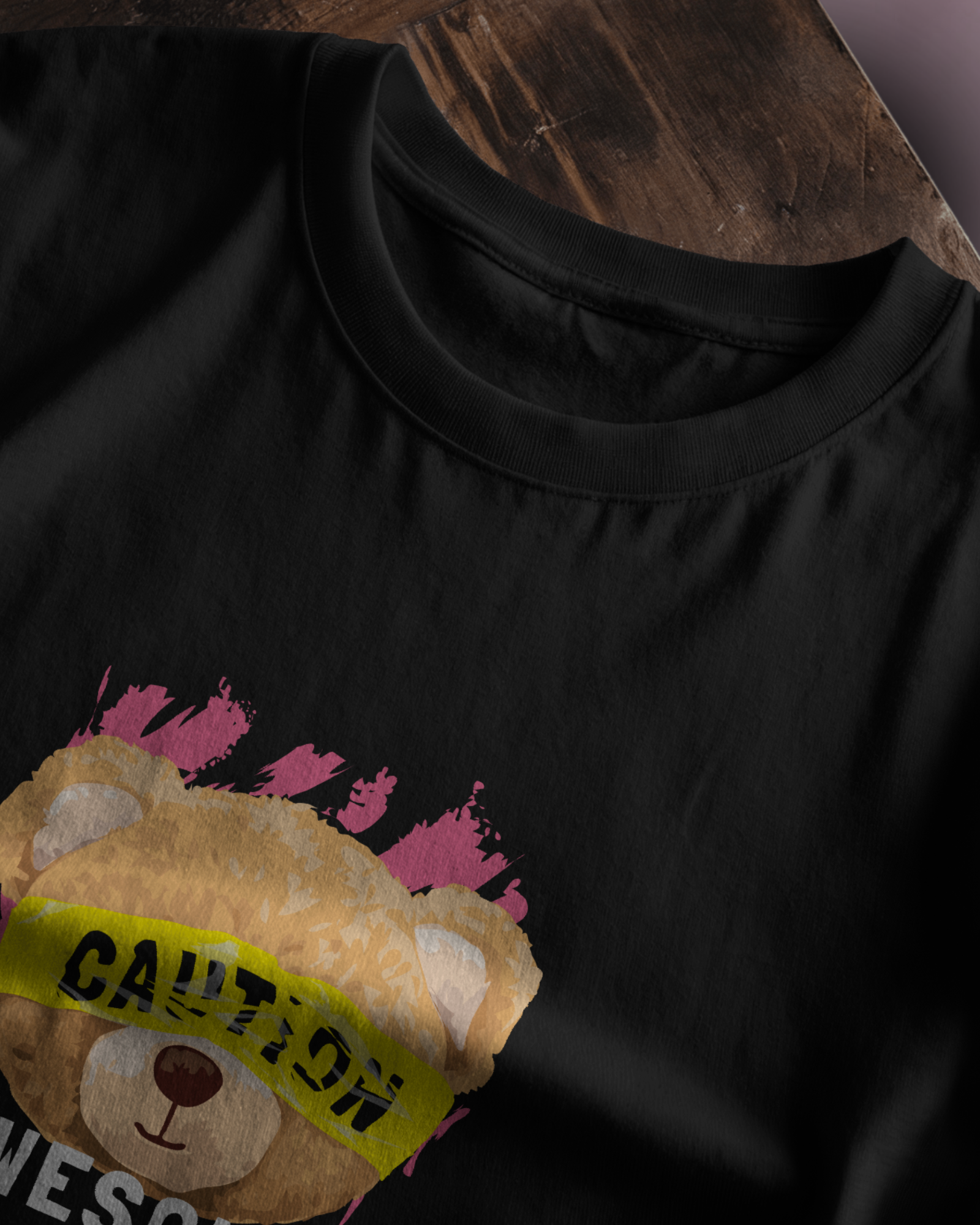Close-up of Qurrito’s Caution Teddy Graphic T-Shirt in regular fit. The fun teddy bear artwork and bright caution label reflect a playful, quirky streetwear mood.
