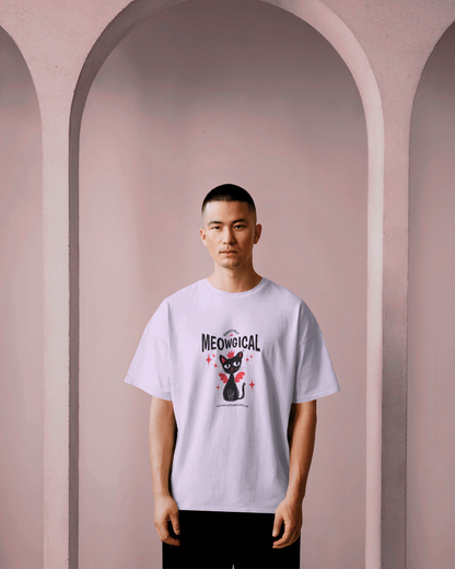 Male model wearing a Qurrito white oversized t-shirt with a graphic "Meowgical" design against a purple background