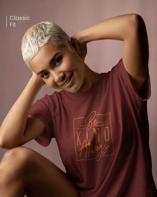 Smiling woman wearing Qurrito’s Be Kind Always maroon cotton t-shirt in a regular fit. This minimalist motivational design captures happy, romantic, cheerful, and affectionate moods — effortlessly blending positivity with everyday comfort.