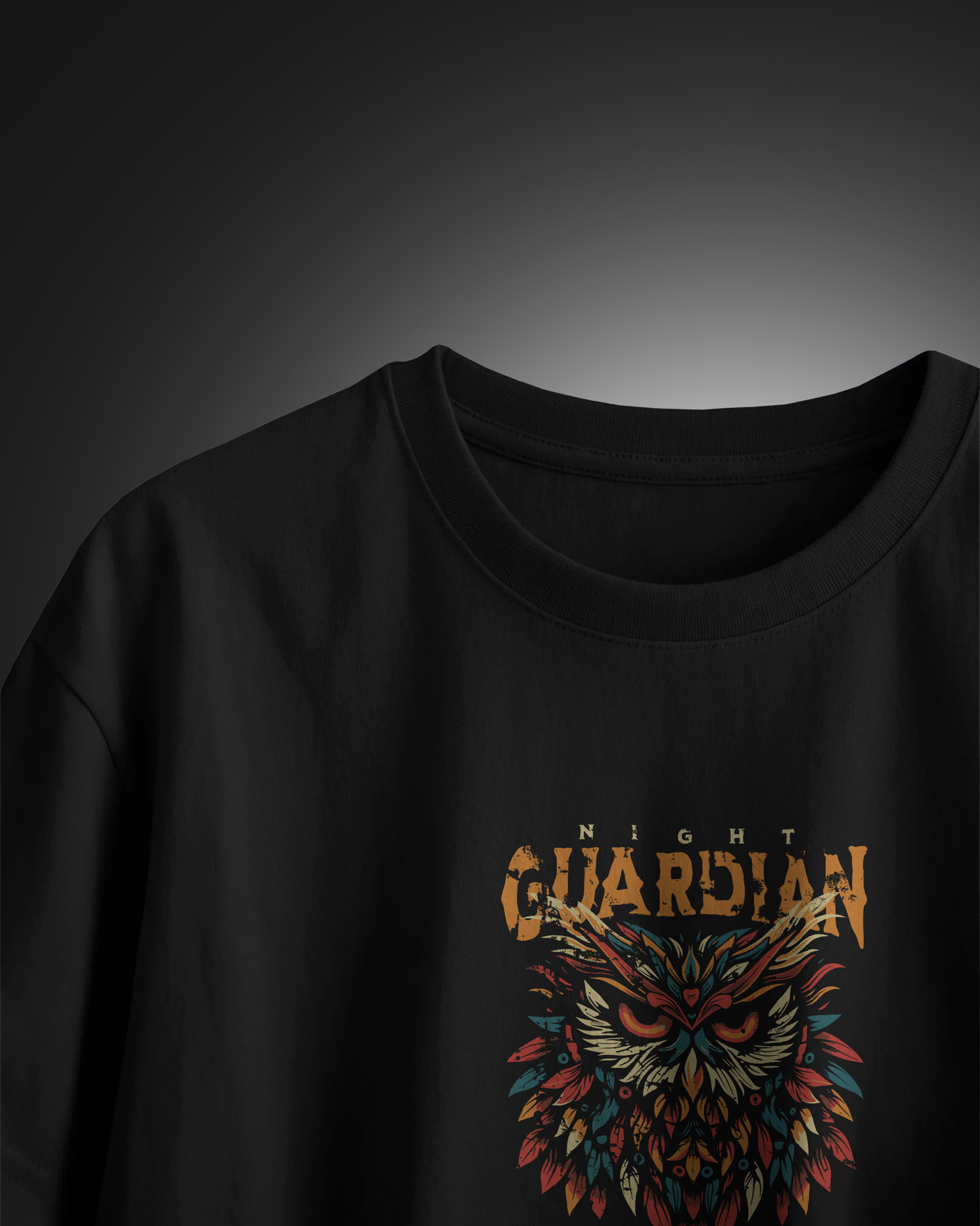 Closeup of man in dark, mysterious lighting wearing "Night Owl" T-shirt. Focused mood. Aesthetic streetwear regular fit design by Qurrito.
