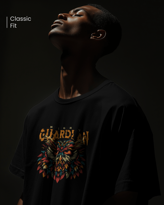 Closeup of man in dark, mysterious lighting wearing "Night Owl" T-shirt. Focused mood. Aesthetic streetwear regular fit design by Qurrito.