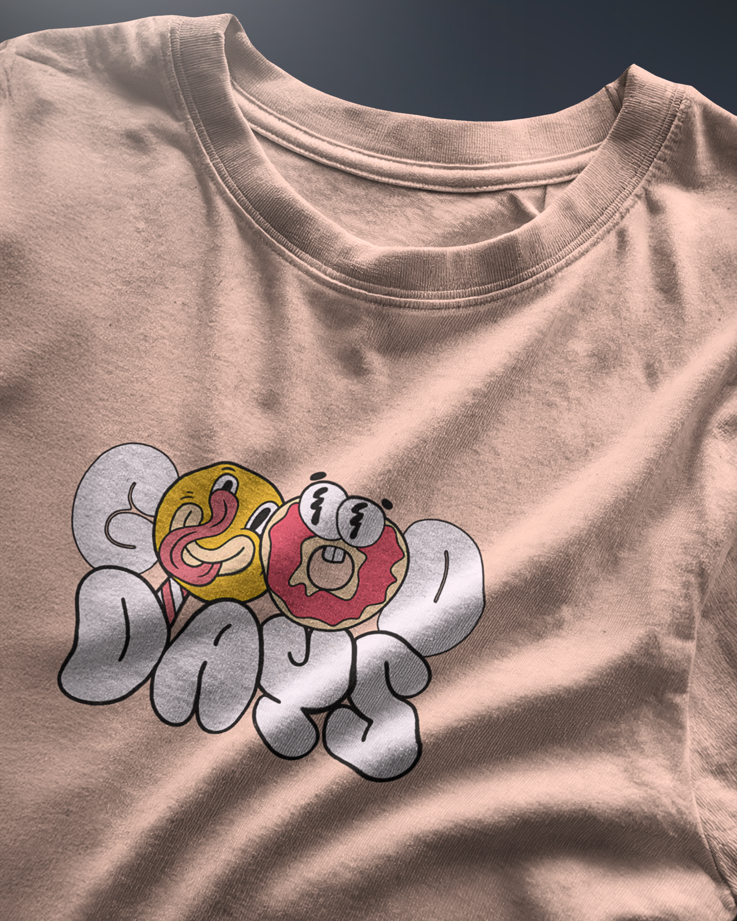 Energetic "Good Days Funky Typography Tee" graphic tee with a playful donut and smiley character. Peach colored Regular Fit shirt by Qurrito for a vibrant look.