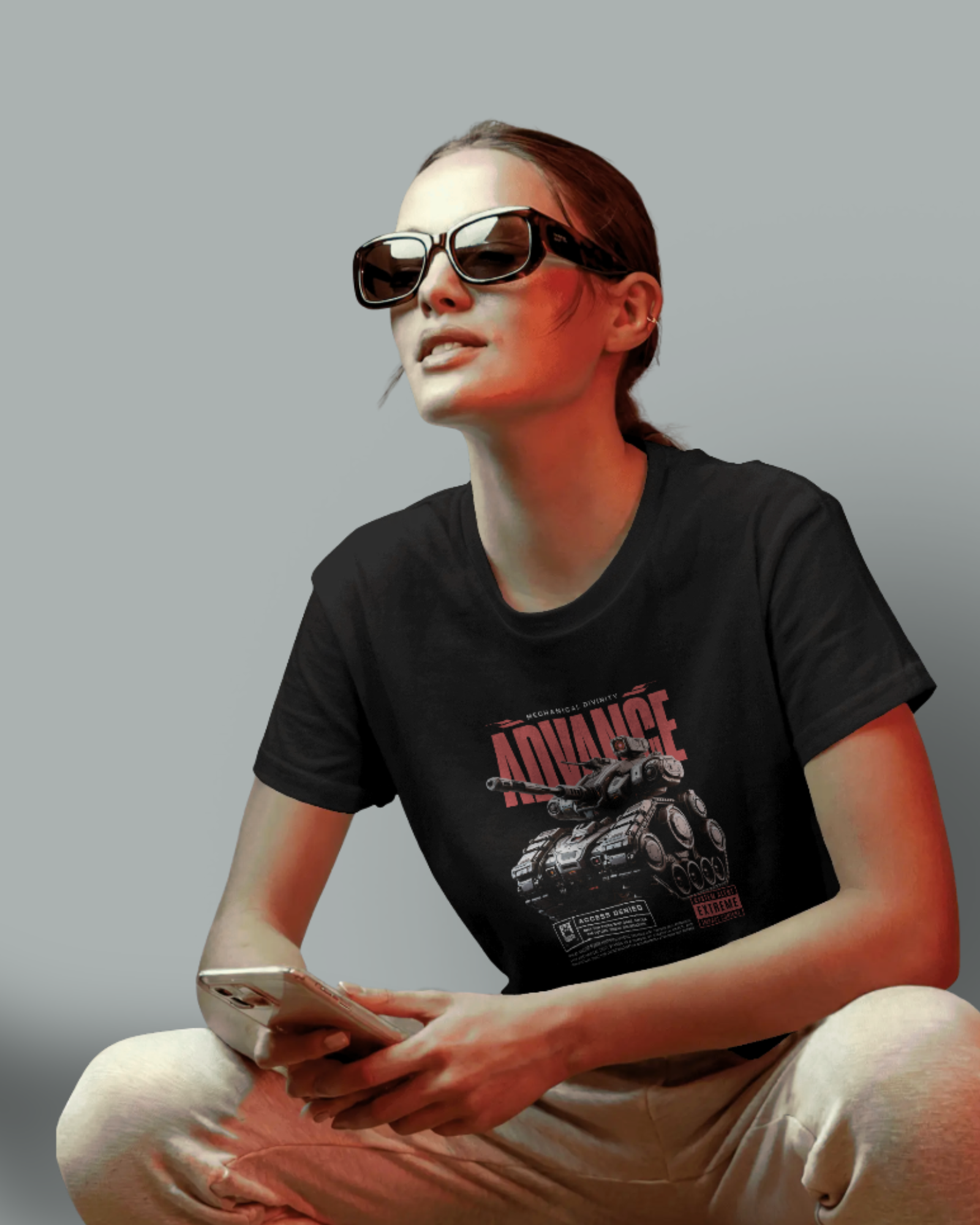 Female model with a focused and confident expression wearing the Qurrito Tactical Edge regular fit t-shirt and sunglasses. This serious unisex top features a tank graphic and is a bold mood  streetwear choice.