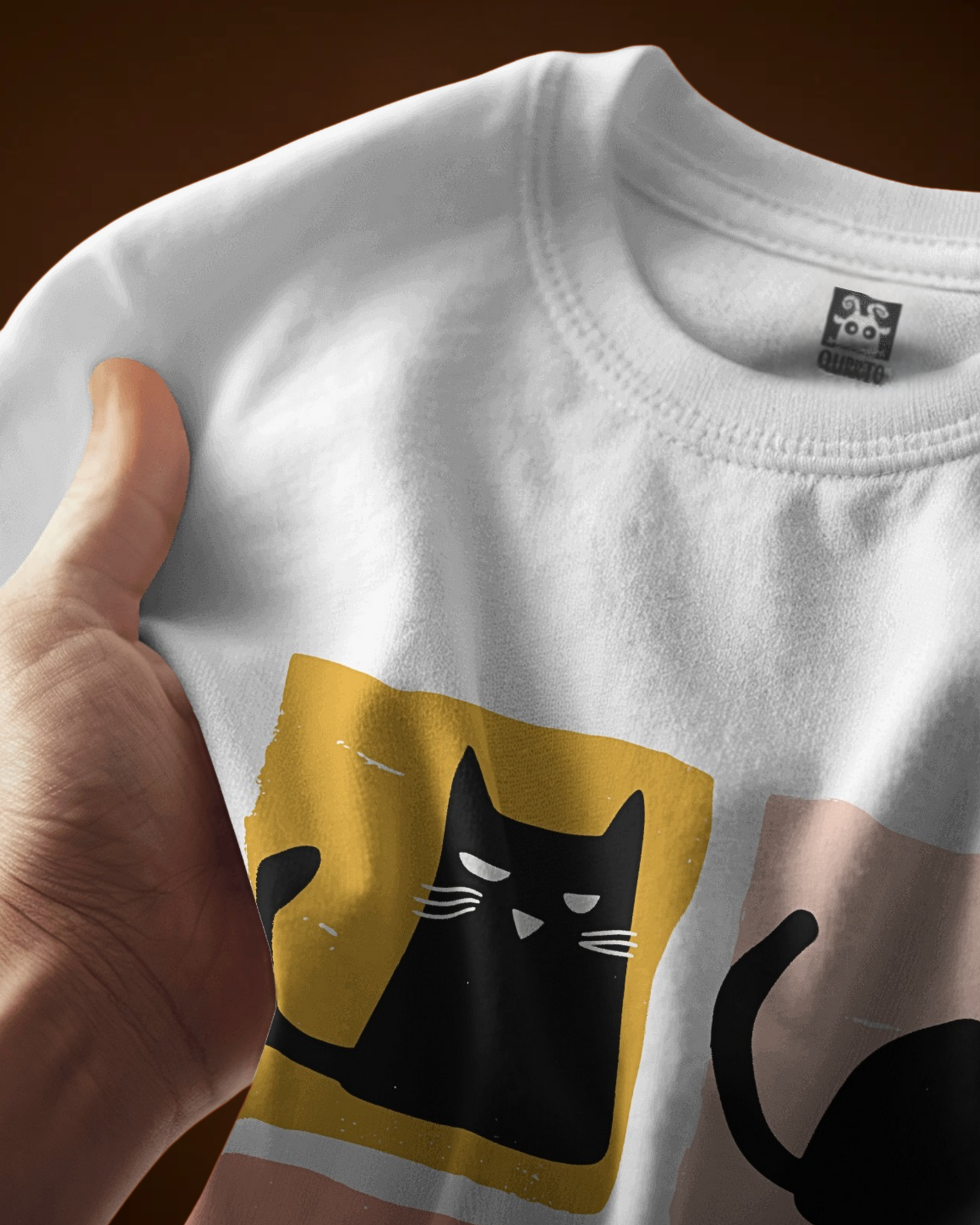 Close-up of Qurrito’s Funny Cat Print T-Shirt showing soft cotton fabric texture and bold quirky cat graphic print in pastel tones. Keywords: funny cat print, premium cotton t-shirt, graphic design closeup.