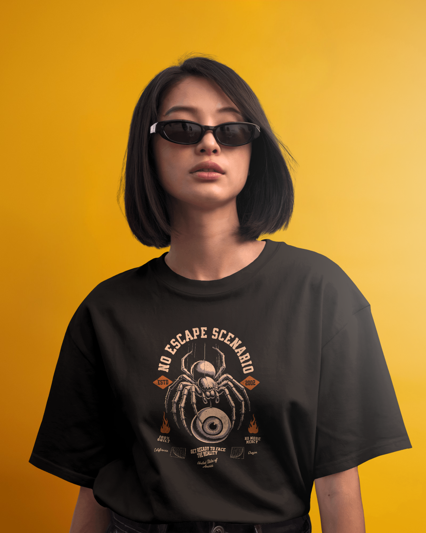 Female model wearing Qurrito’s Gothic Horror Spider Eye Graphic T-Shirt in black, featuring detailed spider and eye print, crafted from soft mid-heavy cotton for an oversized urban streetwear look.