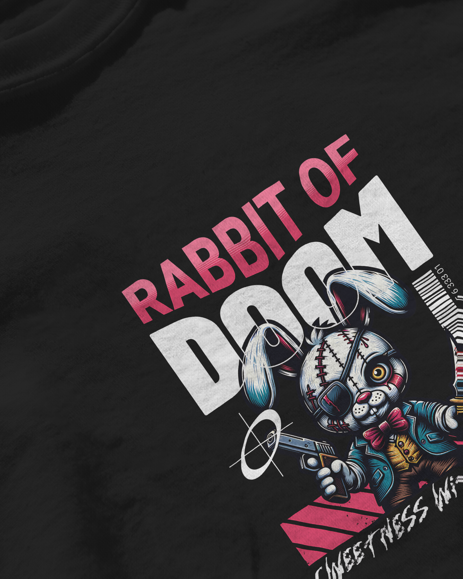 Closeup of the quirky Killer Bunny design on a black T-shirt. Playful but dark aesthetic with a zombie rabbit holding a gun. Alternative streetwear by Qurrito.