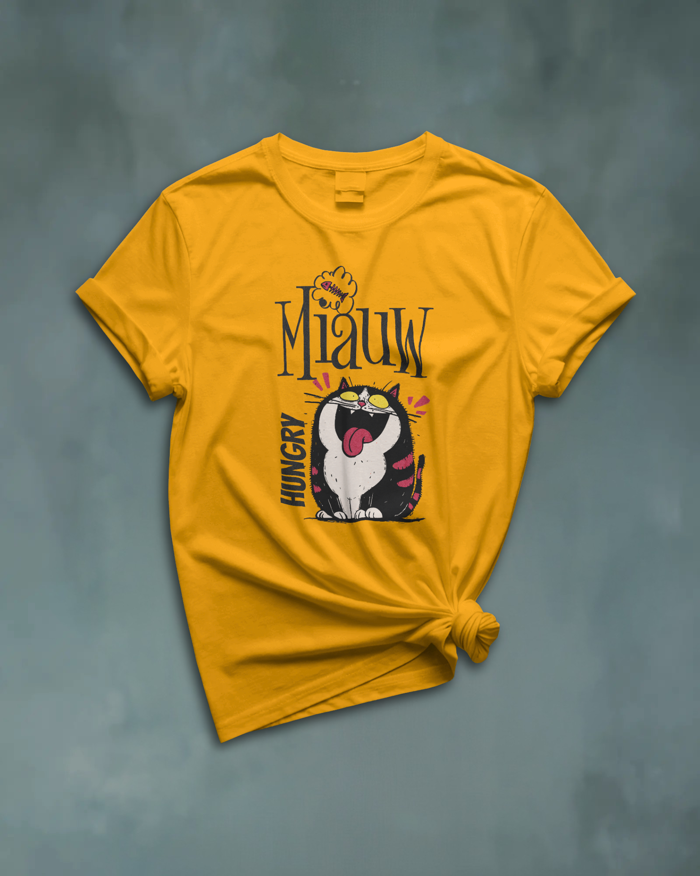 Qurrito Level 100 Hangry graphic t-shirt in Regular Fit displayed knotted in a flat lay style. The mustard yellow tee features an Energetic Funny Graphic print of a large, hungry cat with its tongue sticking out.