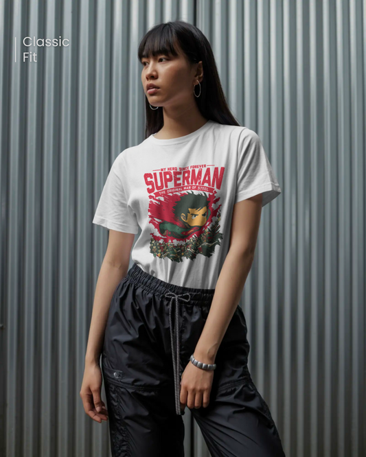 Qurrito Man of Steel graphic t-shirt in Classic Fit worn by a woman with long dark hair. The white tee features a Confident Hero Graphic print of a cute, anime-style Superman flying over a cityscape in red and green colors. Confident mood.