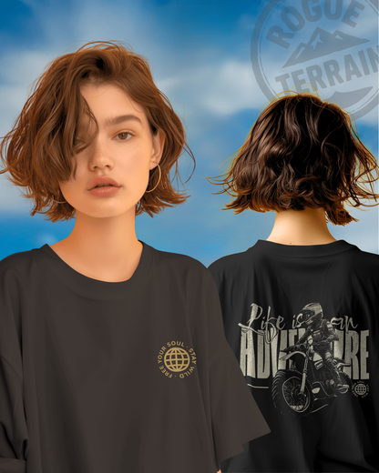 Female model styled in Qurrito’s Oversized Adventure Travel Cotton T-Shirt featuring bold motorbike rider artwork and “Free Your Soul” emblem. The black oversized fit expresses energetic, pumped, confident, and bold moods — ideal for explorers who live life full throttle.