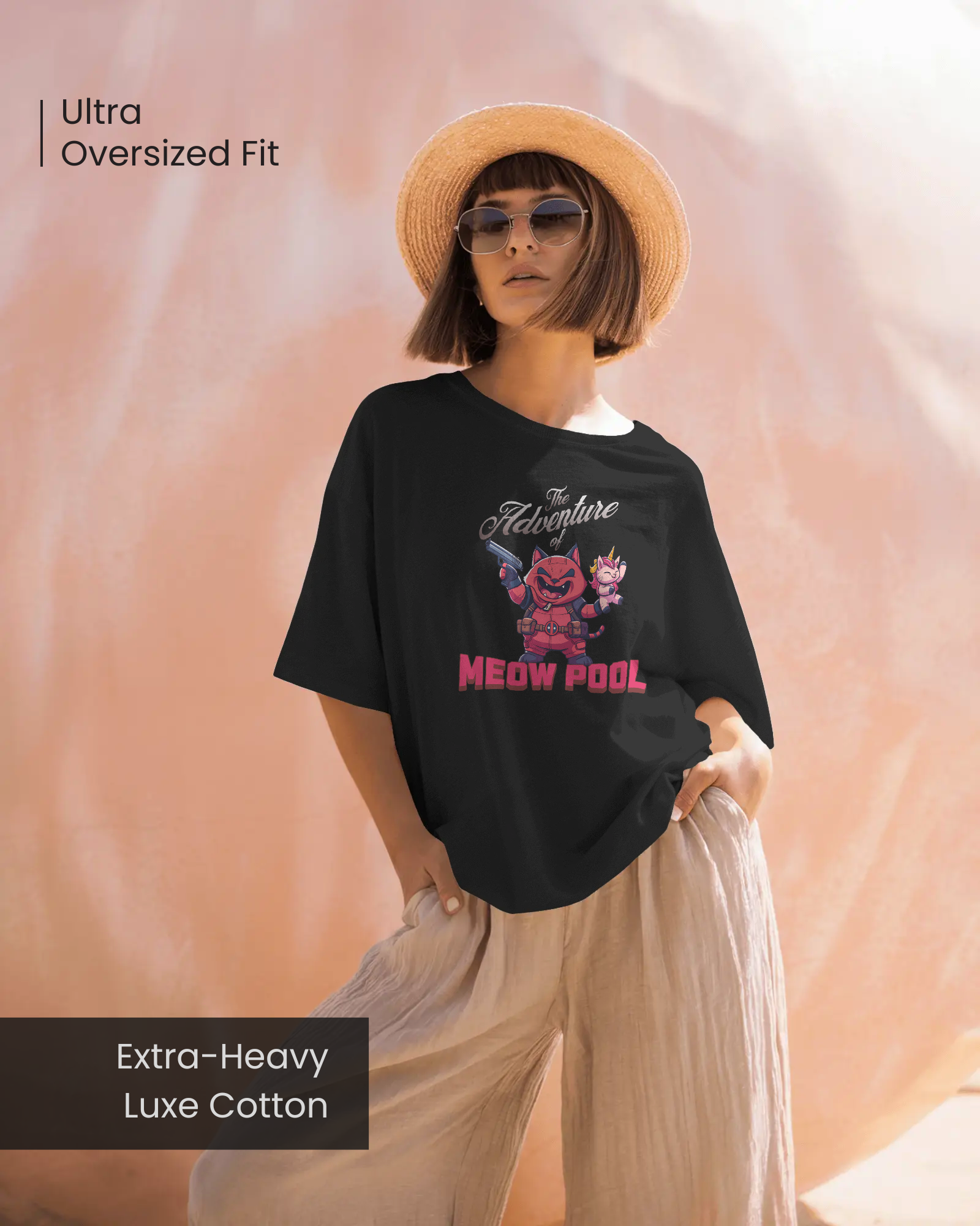 Stylish female model wearing the mysterious "Meow Pool" oversized black t-shirt with a sun hat and wide-leg trousers. This Extra-Heavy Luxe Cotton tee is playful and unisex, giving a loose-fit silhouette.