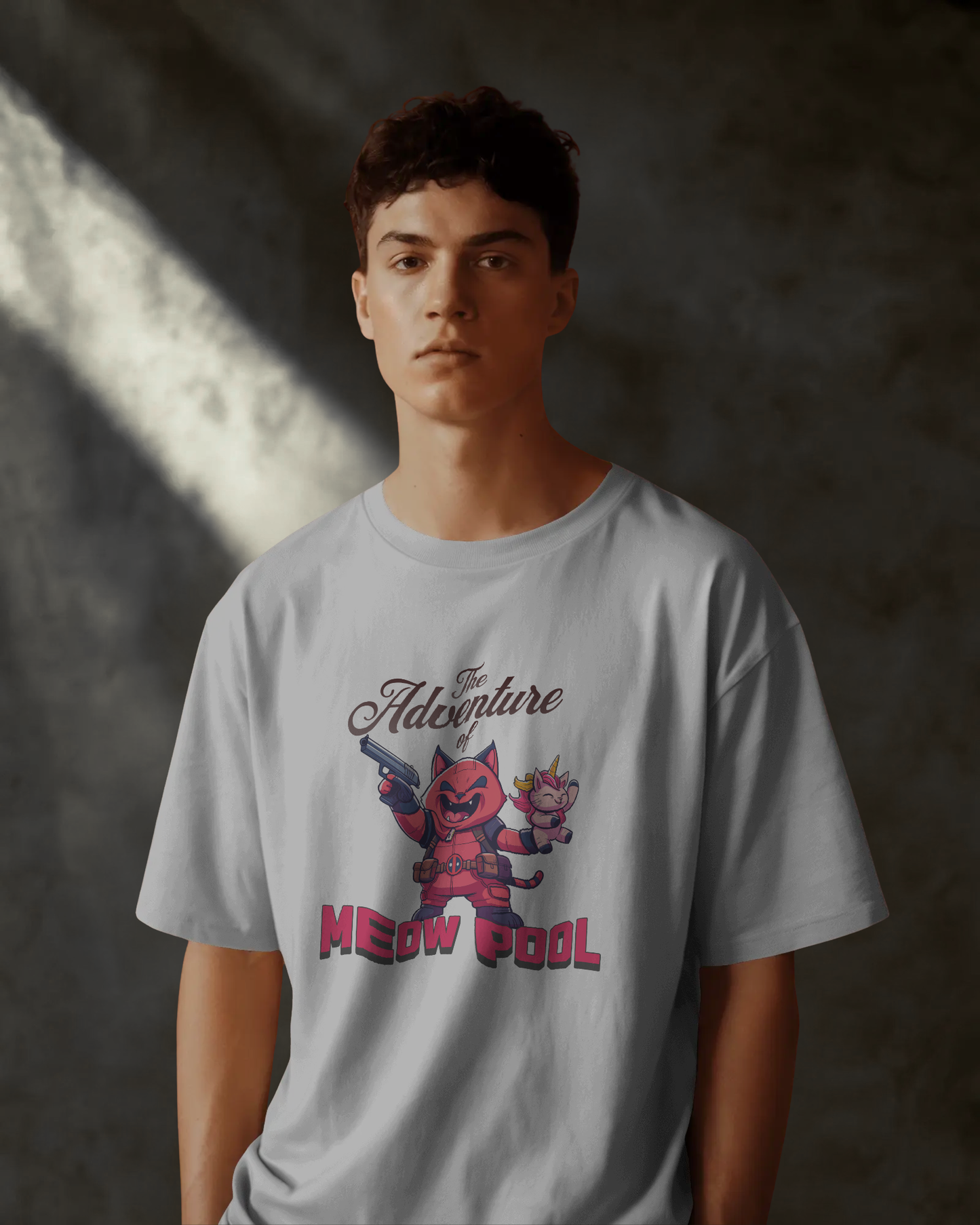 Mysterious mood male model wearing the quirky unisex Meow Pool oversized white t-shirt. Focus on the heavy-cotton feel and dark streetwear style of the garment.