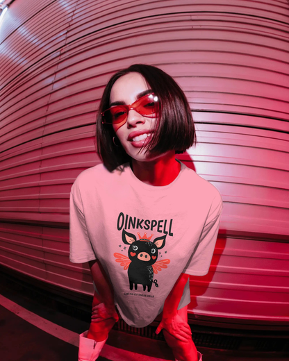 Woman wearing Qurrito’s Oinkspell Quirky Oversized T-Shirt in pink, paired with white sneakers and tinted glasses for a playful, fun, and cheerful mood street look, ideal for women’s casual graphic streetwear fashion.