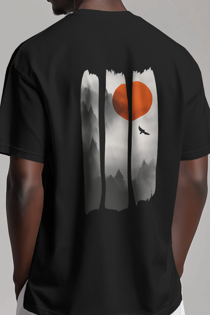 Back of male model wearing Qurrito’s “Sunset Forest” oversized outdoor t-shirt featuring a scenic adventure graphic with an orange sun and misty forest print. The mid-heavy premium cotton tee reflects romantic, affectionate, chill, relaxed, happy, and cheerful moods — perfect for outdoor enthusiasts and mood-based streetwear lovers.