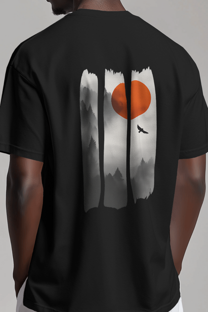 Back of male model wearing Qurrito’s “Sunset Forest” oversized outdoor t-shirt featuring a scenic adventure graphic with an orange sun and misty forest print. The mid-heavy premium cotton tee reflects romantic, affectionate, chill, relaxed, happy, and cheerful moods — perfect for outdoor enthusiasts and mood-based streetwear lovers.