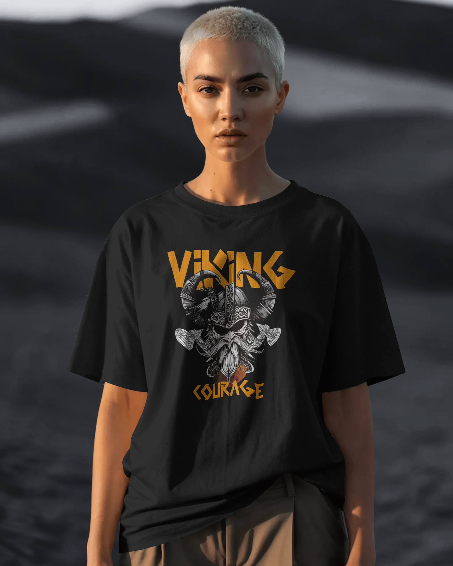 A woman wearing Qurrito’s Oversized Viking T-Shirt in black. The fierce Viking helmet and axe graphic radiates confidence and bold mood energy. Styled with beige relaxed fit chinos, perfect for women’s bold streetwear or unisex oversized looks.