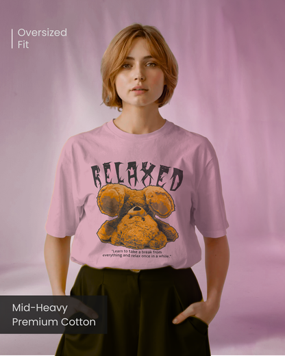Female model wearing Qurrito’s Pink Relaxed Oversized T-Shirt made from mid-heavy premium cotton, featuring a teddy bear graphic with “RELAXED” text, styled in a comfy streetwear fit.
