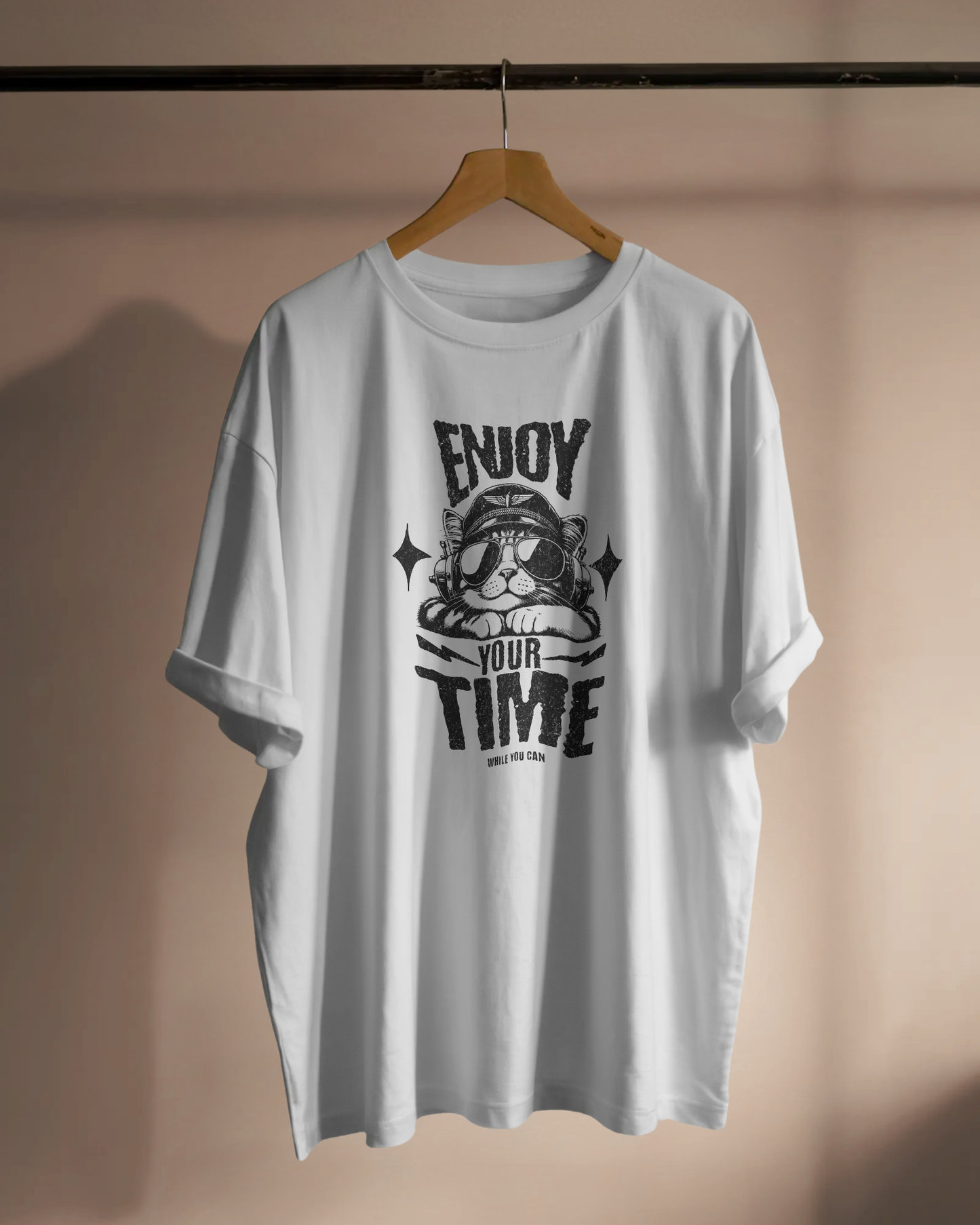 White Positive Message Oversized T-Shirt by Qurrito featuring the quote “Enjoy Your Time” with a cat graphic. The rolled sleeves and soft cotton fabric make it ideal for casual relaxed wear with a cheerful and playful vibe.