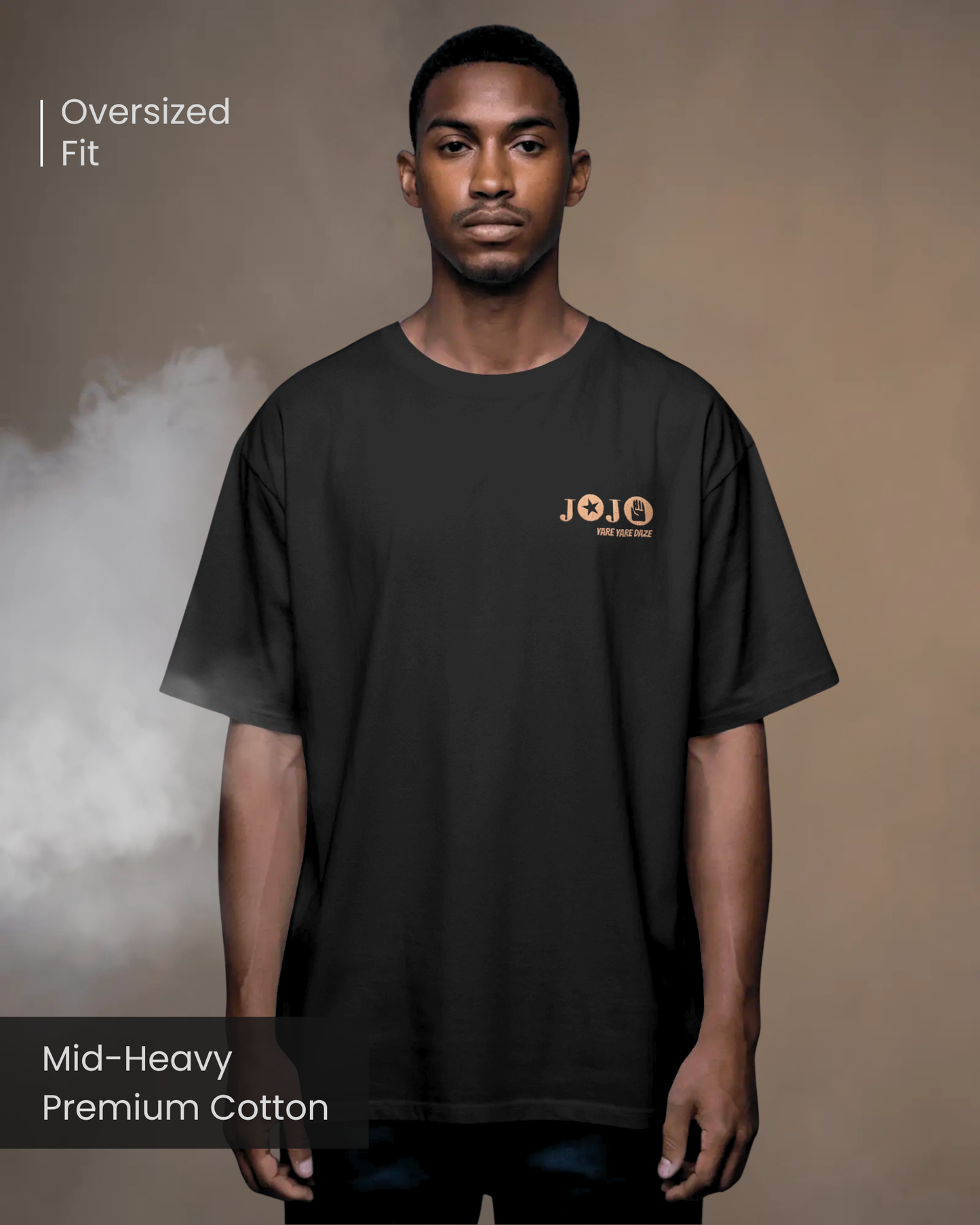 A male model with braided hair wearing Qurrito’s Black Anime Streetwear Oversized T-Shirt featuring JOJO embroidered logo, posed against a smoky beige studio background.