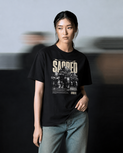 Close front view of QURRiTO Sacred Mecha Divinity cyberpunk t-shirt in black, showing detailed mecha robot graphic with SACRED typography and Mechanical Divinity text on chest.