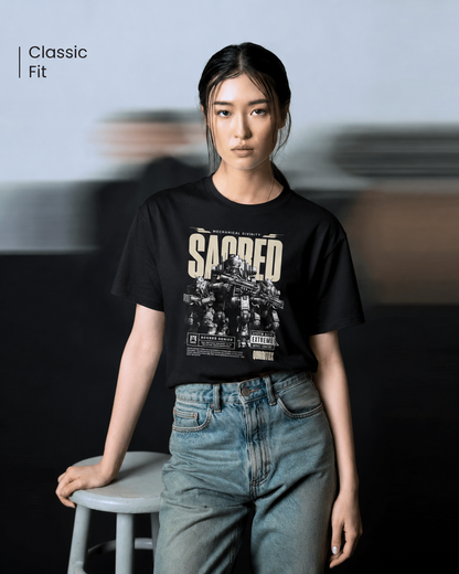 Woman standing with hands in pockets wearing QURRiTO Sacred Mecha Divinity black cyberpunk t-shirt featuring bold SACRED mecha graphic, paired with oversized light wash jeans.