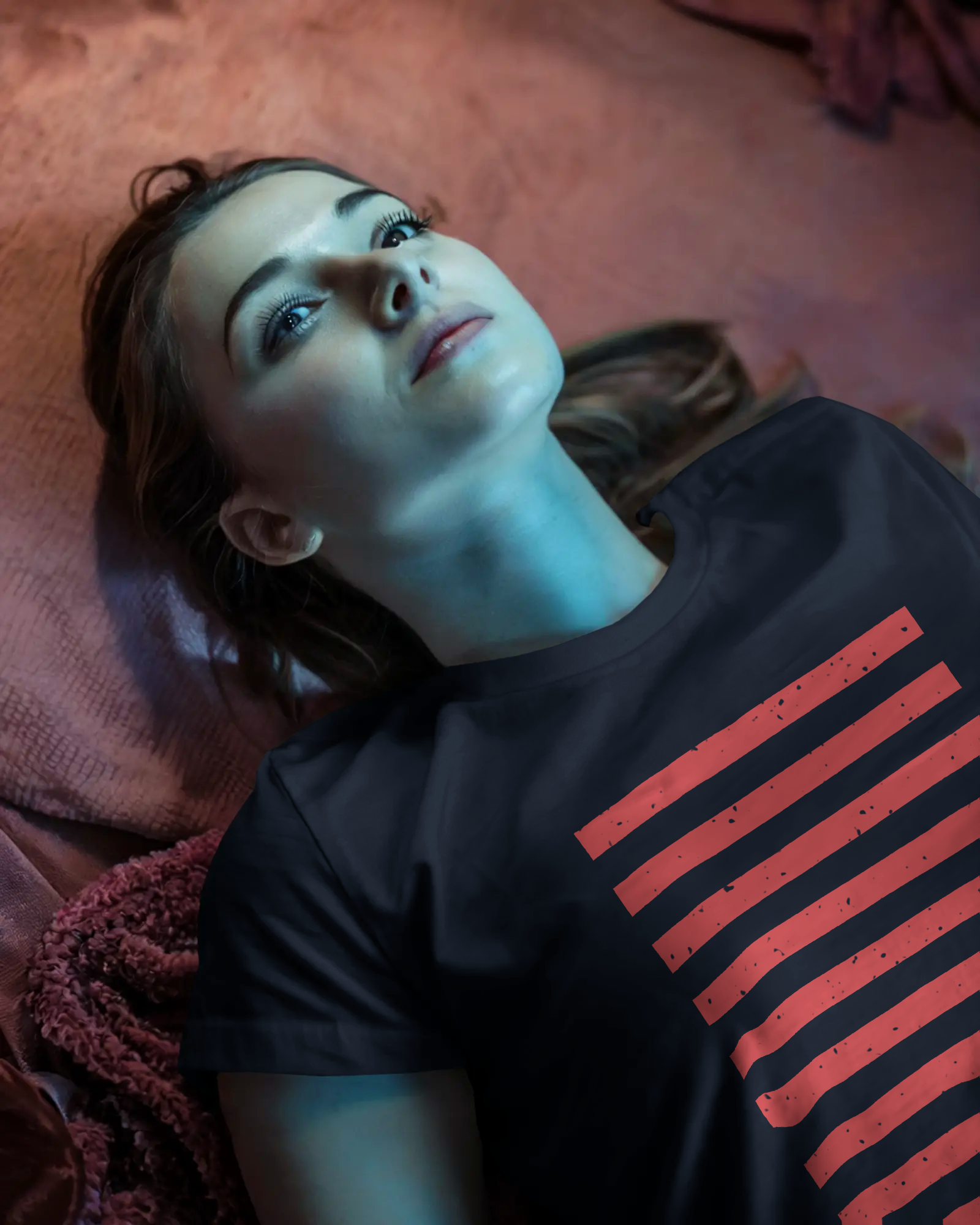 Close-up of a female model in serious and moody lighting wearing the Qurrito Minimalist Stripes of Boldness T-Shirt. This dark navy regular fit tee is a bold choice for casual wear.
