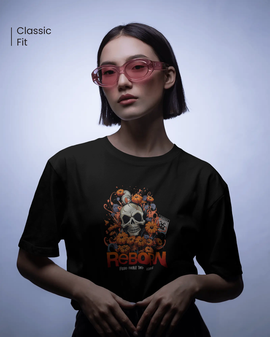 Woman in quirky pink glasses wearing a dark streetwear T-shirt. Design shows a skull surrounded by pumpkins. Mysterious  mood and regular fit by Qurrito
