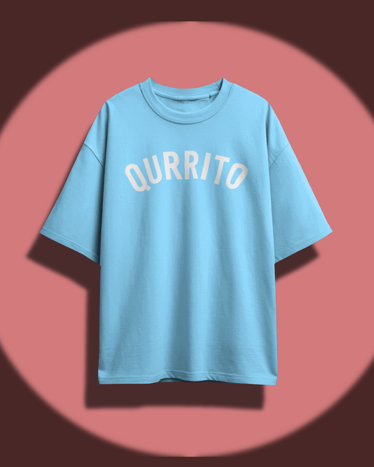 Qurrito’s Sky Blue Branded Oversized Tee displayed against a warm background. The clean, minimal design and soft blue tone evoke a chill, happy, and laid-back aesthetic, perfect for unisex oversized streetwear outfits.
