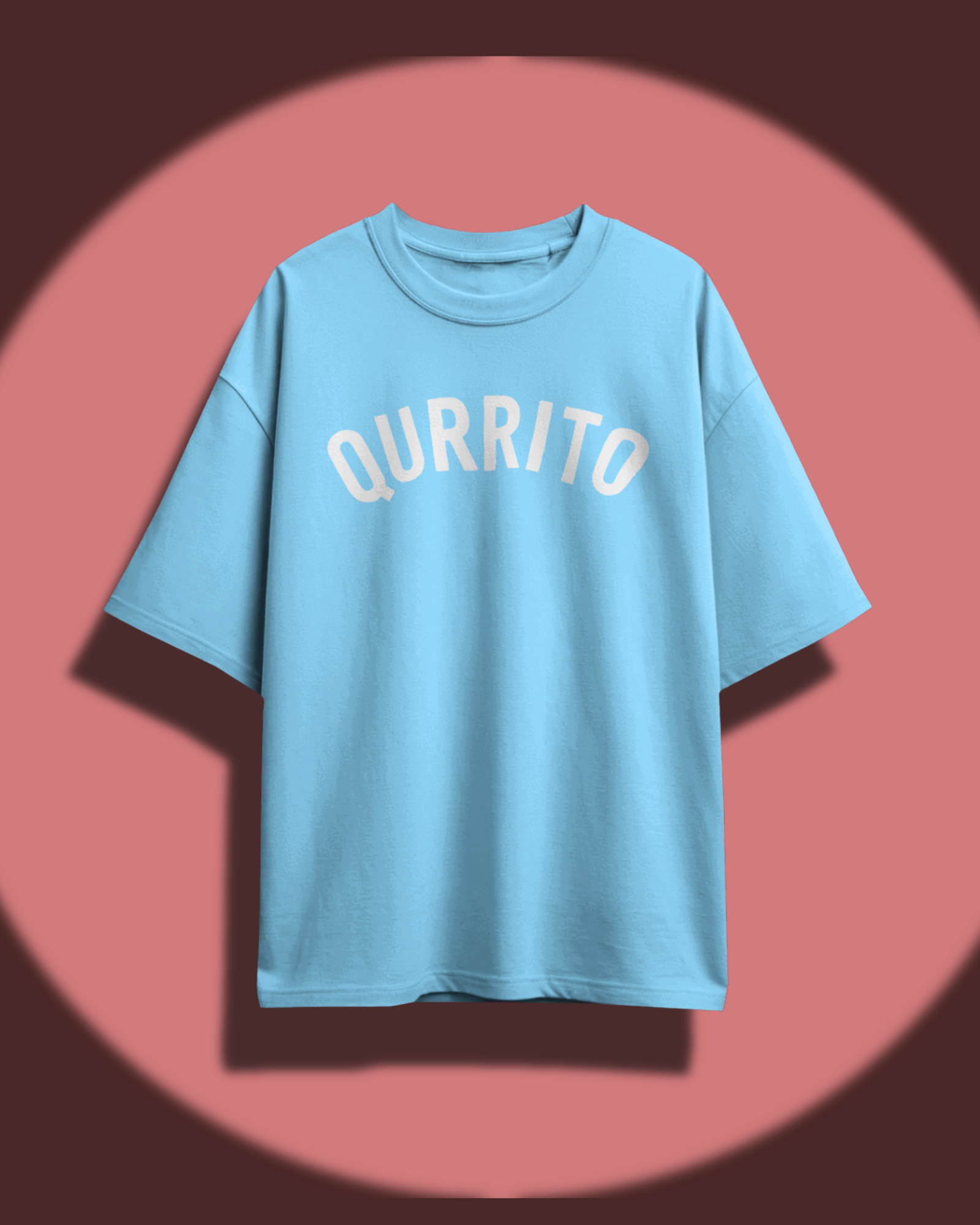 Qurrito’s Sky Blue Branded Oversized Tee displayed against a warm background. The clean, minimal design and soft blue tone evoke a chill, happy, and laid-back aesthetic, perfect for unisex oversized streetwear outfits.