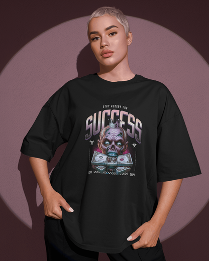 curvy Woman wearing Qurrito’s Success Zombie Crown Oversized T-Shirt. The gothic artwork blends playful and quirky energy with a dark, confident mood — a statement piece for streetwear lovers.