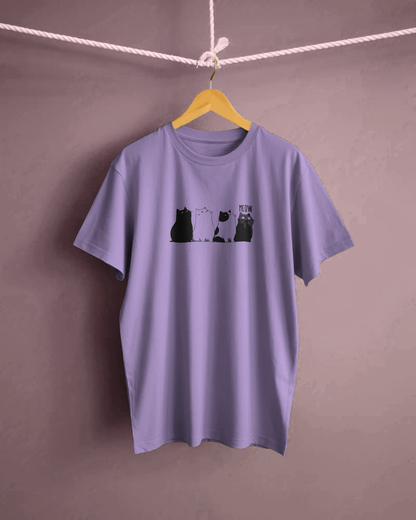 Qurrito The Purr-ple Squad graphic t-shirt in Regular Fit on a hanger. The Lilac tee displays a Chill Cat Graphic print of three black and white cats sitting side-by-side with "MEOW."