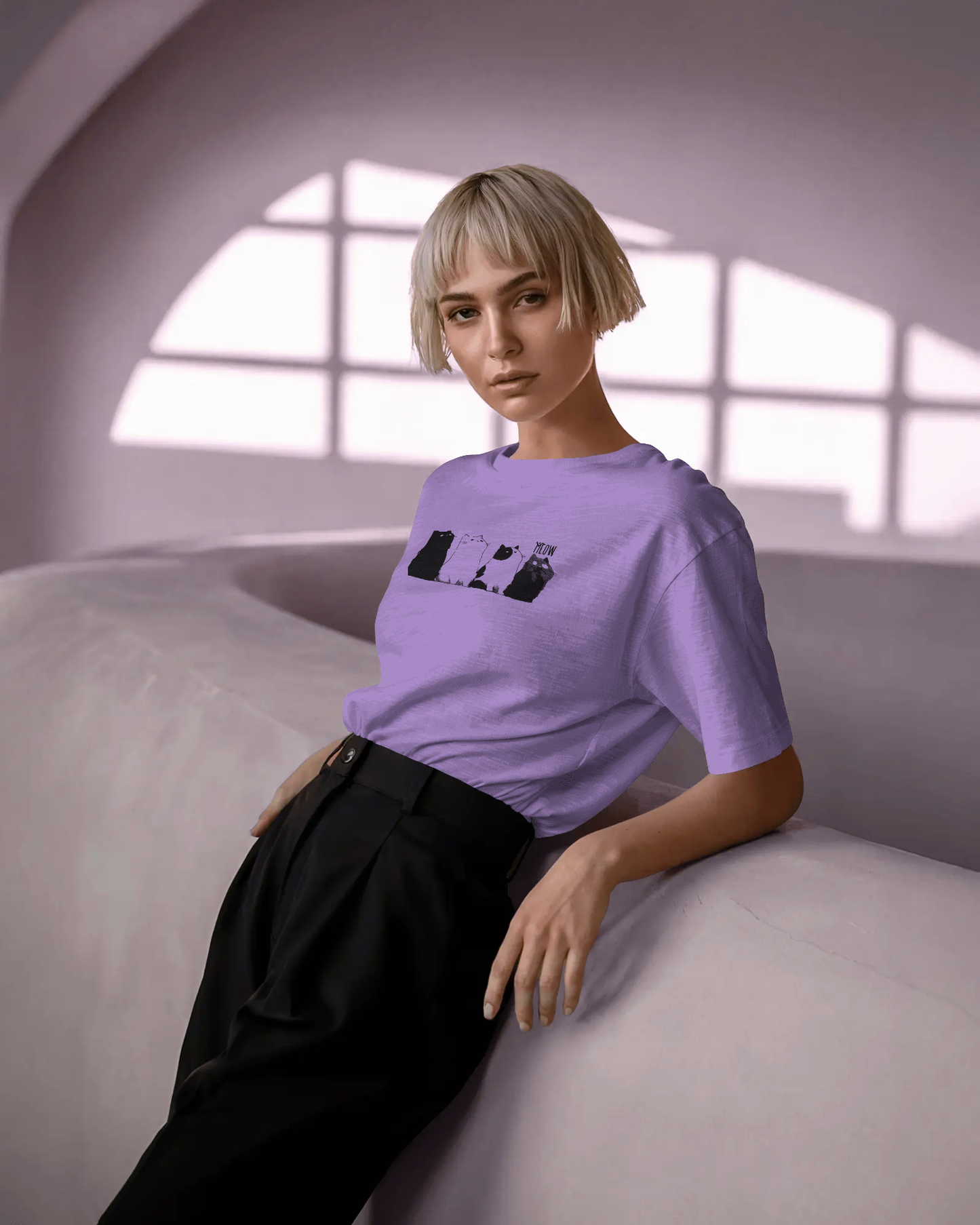Qurrito The Purr-ple Squad graphic t-shirt in Regular Fit worn by a woman with short blonde hair. The Lilac tee features a row of black and white cats in a Chill Cat Graphic print. Chill mood.