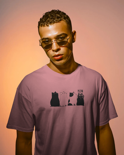 Qurrito The Purr-ple Squad graphic t-shirt in Regular Fit worn by a man with sunglasses. The Mauve/Dusty Rose tee features the Chill Cat Graphic print of four black and white cats. Chill mood.