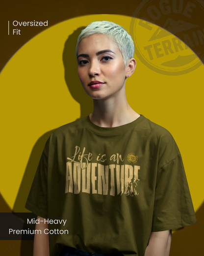 female model styled in Qurrito’s “Life is an Adventure” Travel Inspired Oversized T-Shirt made with soft mid-heavy premium cotton. The earthy tones and relaxed silhouette express energetic, pumped, chill, relaxed, grumpy, and irritated moods — perfect for travelers and mood-driven streetwear lovers.