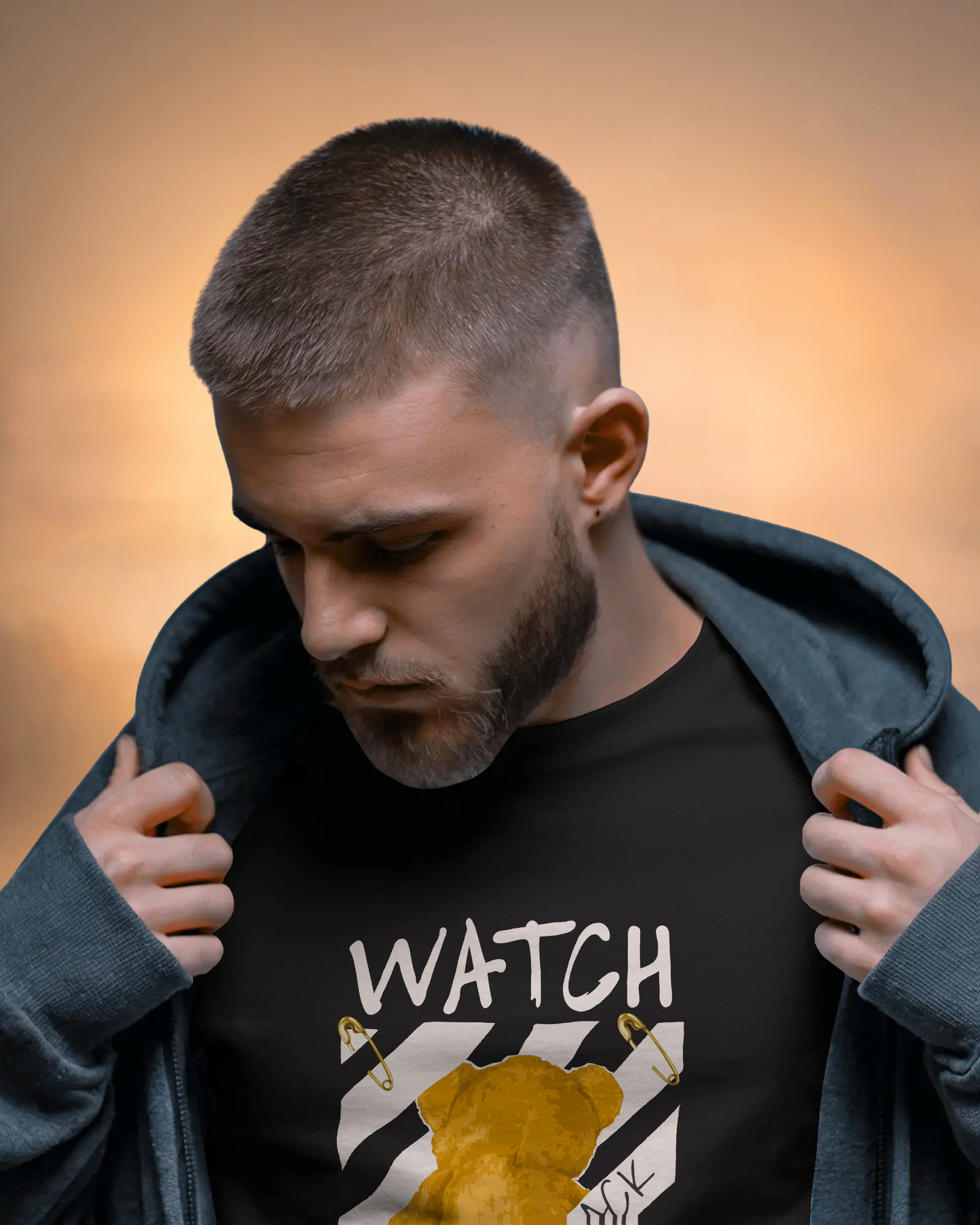 Man wearing Qurrito’s Urban Graphic Black Tee – “Watch Your Back” Regular Fit, layered with a dark hoodie for a bold streetwear outfit for men. The look gives mysterious and confident streetwear vibes, perfect for urban fashion enthusiasts searching for dark graphic tees.